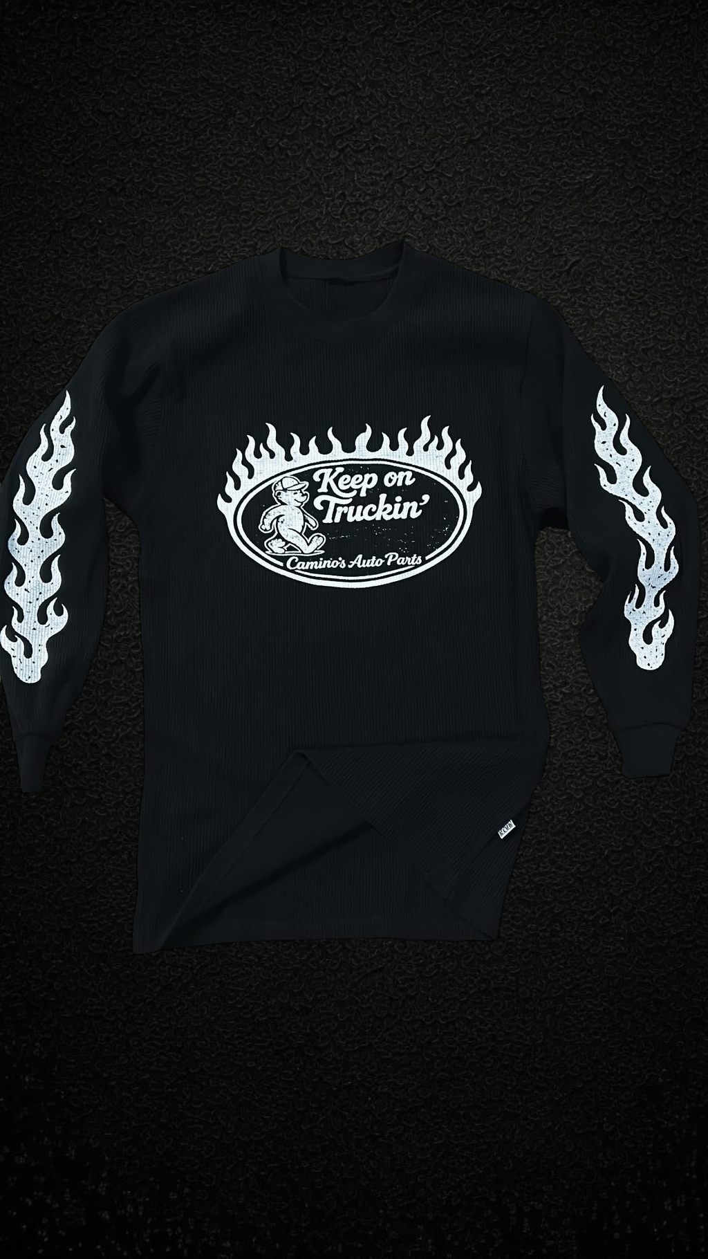 Camino’s Auto Parts black thermal long sleeve shirt with white bear graphic and flame sleeve prints.