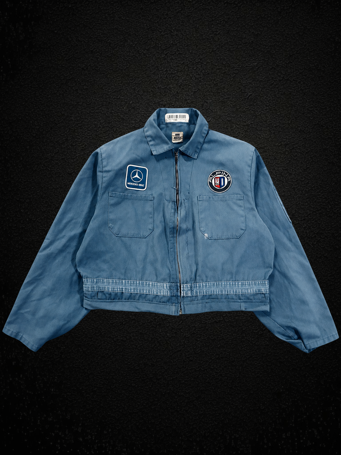 Camino’s Auto Parts reworked blue cotton jacket featuring Mercedes Benz and Alpina patches with a front zip closure.