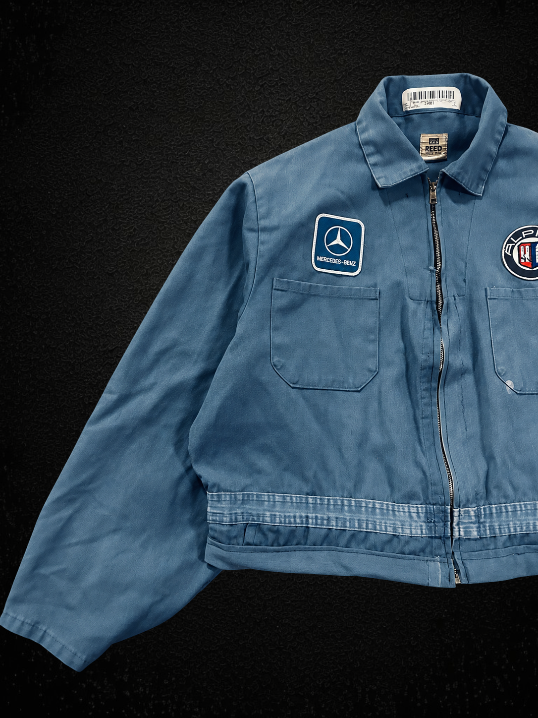 Camino’s Auto Parts blue reworked Mercedes Benz and Alpina patch jacket with front zipper and chest pocket