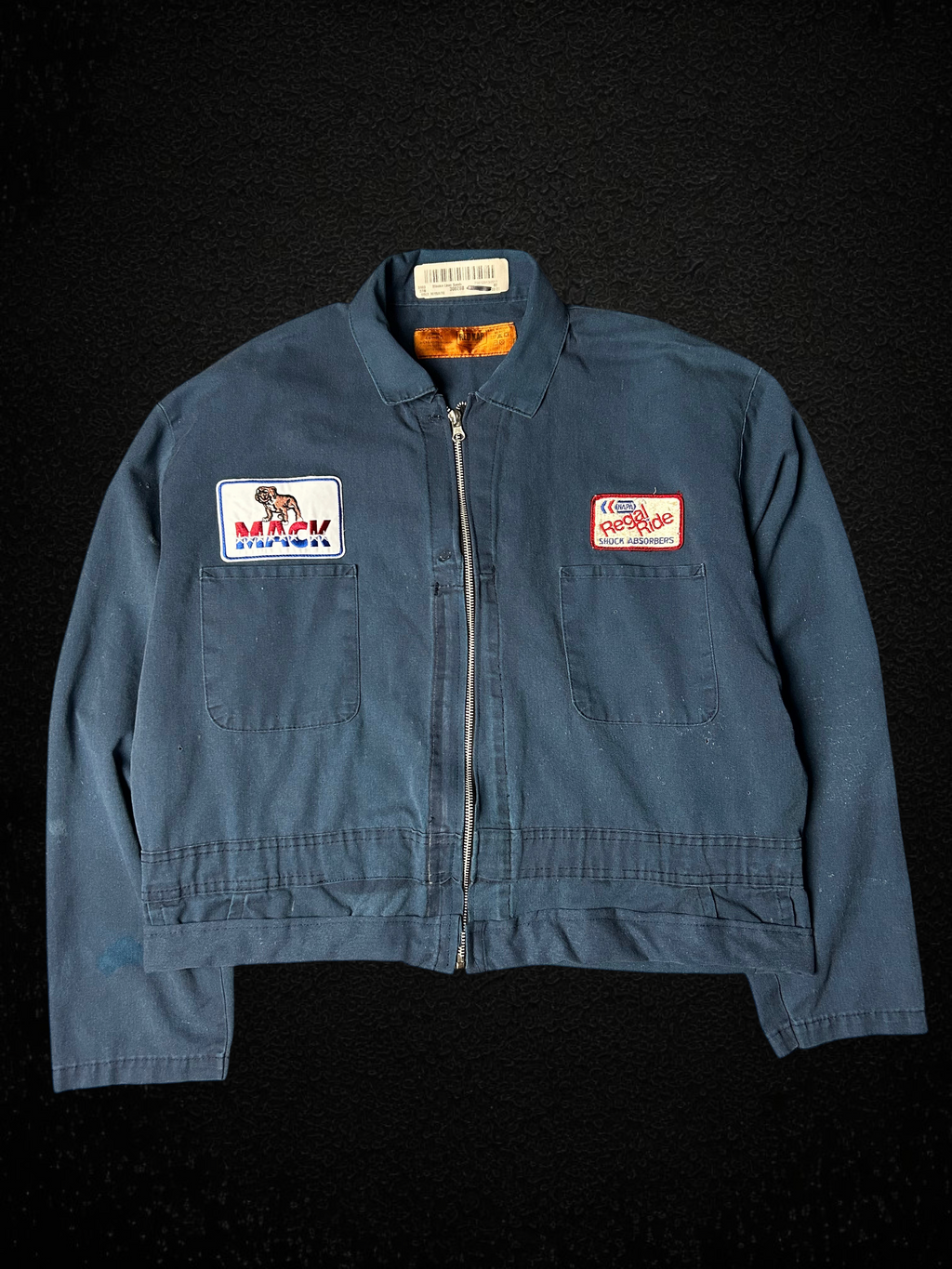 Camino’s Auto Parts upcycled blue cropped trucker jacket featuring vintage Mack Trucks and Napa patches.