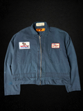 Camino’s Auto Parts upcycled blue cropped trucker jacket featuring vintage Mack Trucks and Napa patches.