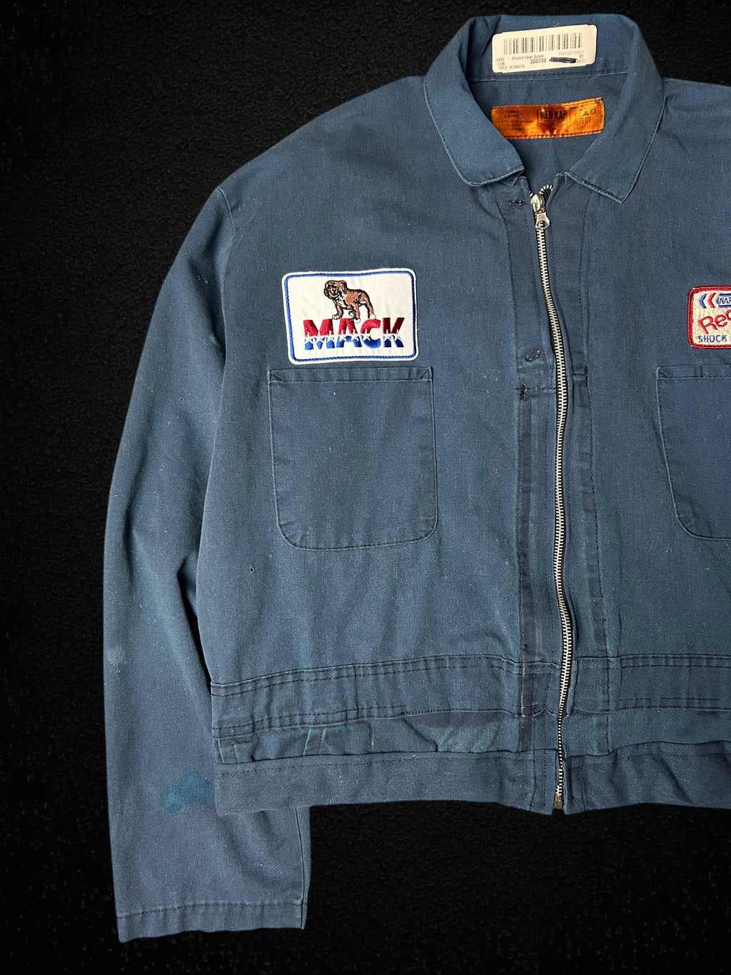 Camino’s Auto Parts upcycled blue cropped trucker jacket featuring vintage Mack Trucks and Napa patches.