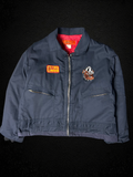 Camino’s Auto Parts upcycled navy insulated trucker jacket with Mack Trucks Bulldog and custom patches.