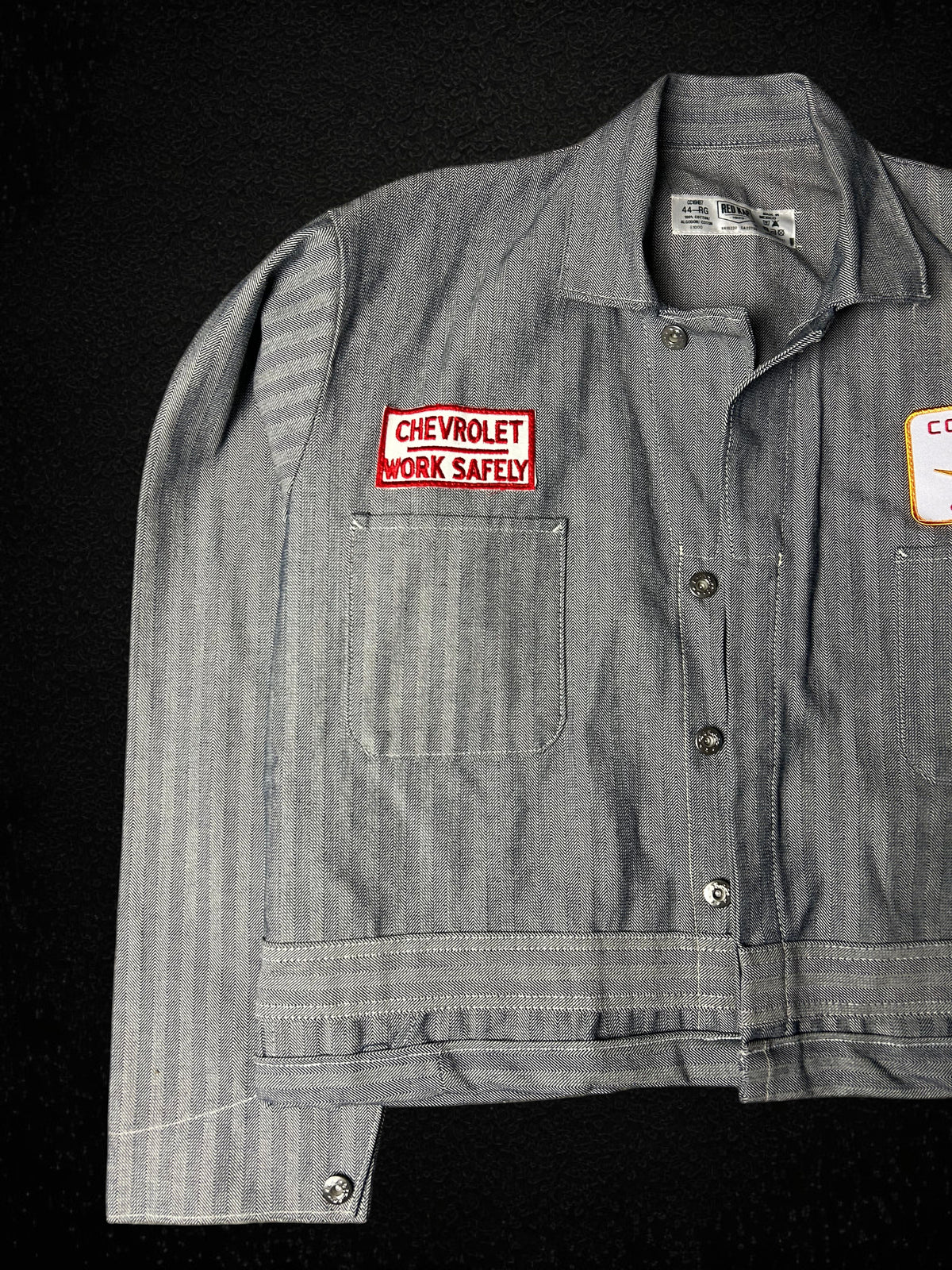 Camino’s Auto Parts reworked grey herringbone twill trucker jacket with Chevrolet Work Safely patch, size Large.