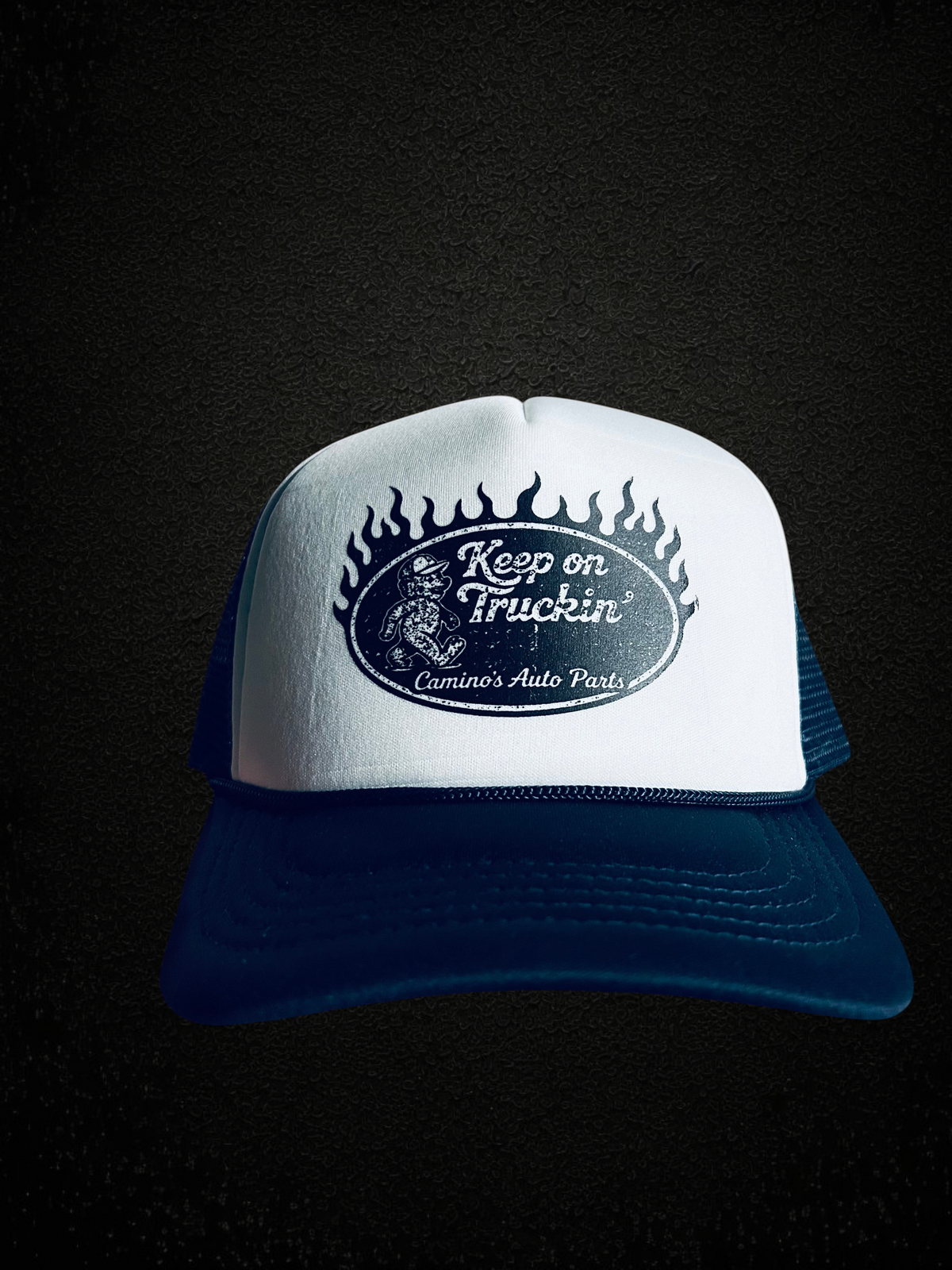Camino’s Auto Parts vintage style navy and white foam trucker hat with Keep On Truckin flame graphic and snapback